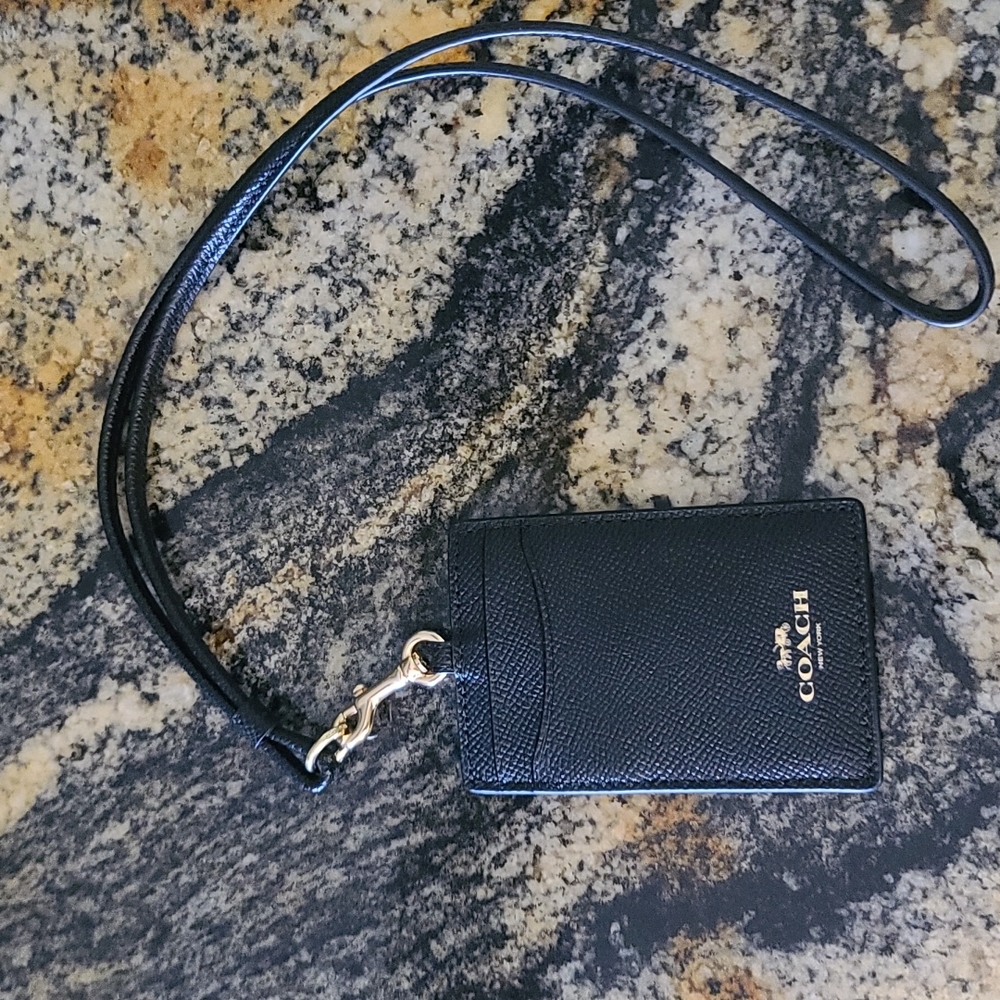 Like new! Authentic Coach Lanyard ID Card Holder in black.